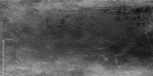Aged vintage paper texture and dark grunge concrete wall surface create a dirty gray textured pattern backdrop for a blank black and white design