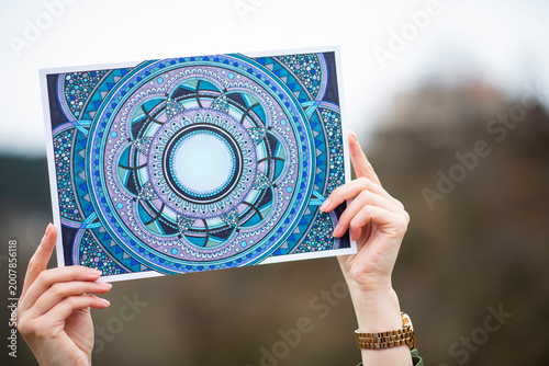 Quadro su tela Woman hands holding mandala pattern, meditation, balance and wellness concept