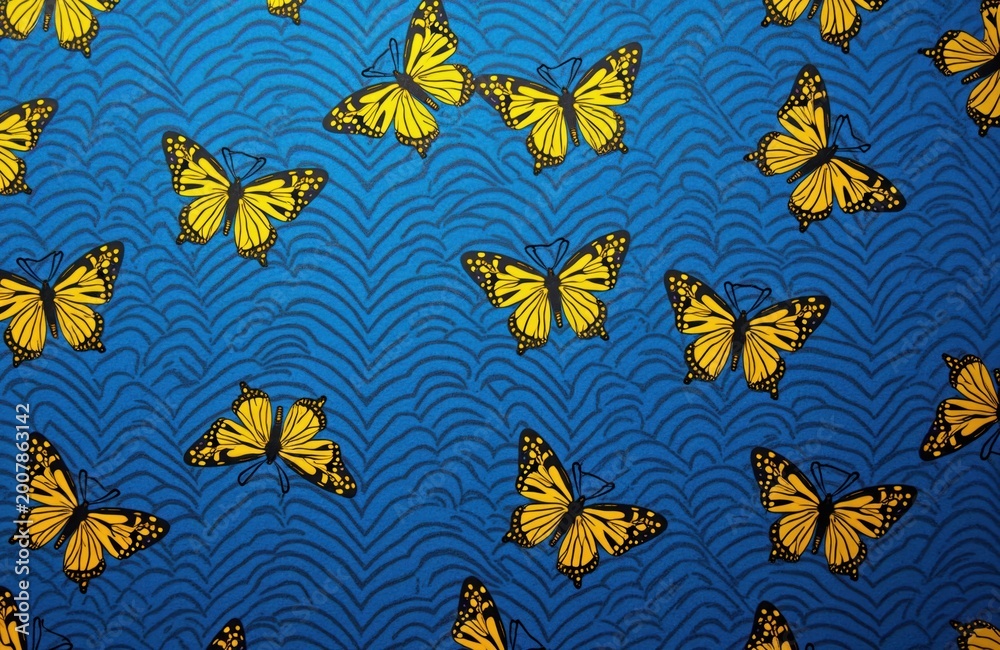 Fototapeta premium Yellow butterflies fly on blue wavy pattern background. Simple insect seamless repeat motif. Nature inspired fabric design for decor apparel.