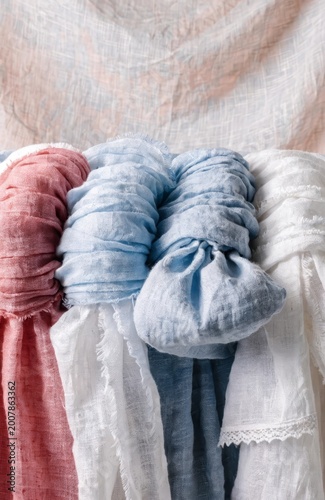 Linen textile background, layers in pastel tones, horizontal composition, soft natural light
