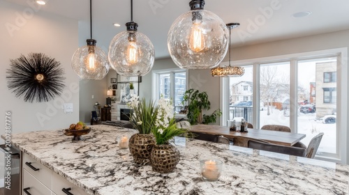 Modern kitchen with island and dining area overlooks a snowy neighborhood.