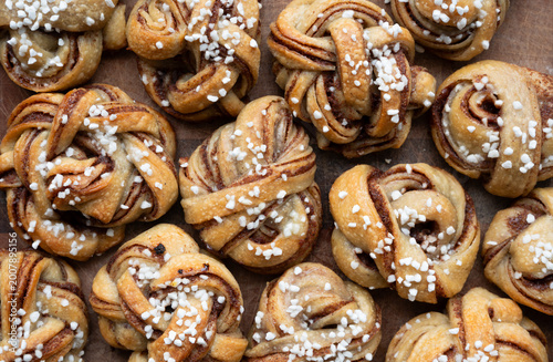 Rustic, homemade sourdough kanelbullar on a wood surface