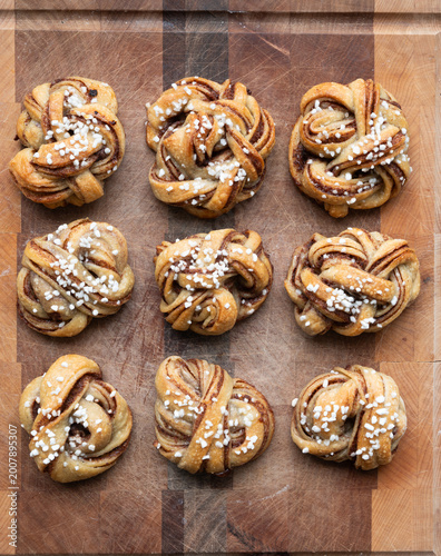 Overhead Flat Lay of Sourdough Braided Kanelbullar Swedish Buns on Wood Surface