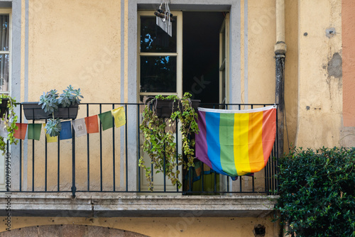 Rainbow pride flag hanging on apartment balcony