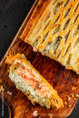 Salmon Wellington seafood lunch or dinner salmon en croûte fish in pastry tasty snack fresh, delicious, gourmet food background on the table  rustic food top view copy space