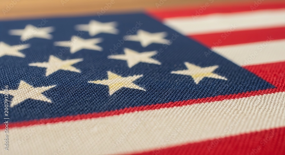 Obraz premium American flag with white stars on blue field and red white stripes closeup
