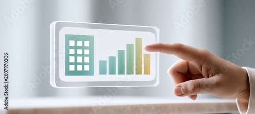 Hand points to property score card with building icon and bar chart on office desk