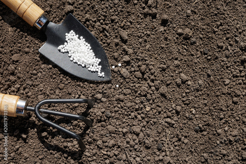 Foto Gardening Tools with Ammonium Nitrate on Soil Surface