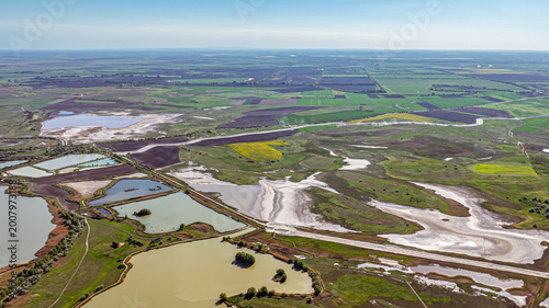 Bilde på lerret Aerial view of fish ponds and surrounding dry wetlands showing contrast of water