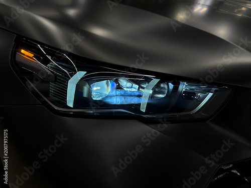 Photos Front BI-LED headlight on a black matte car
