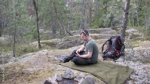 Male Hiker Resting on Camping Mat in Nordic Forest