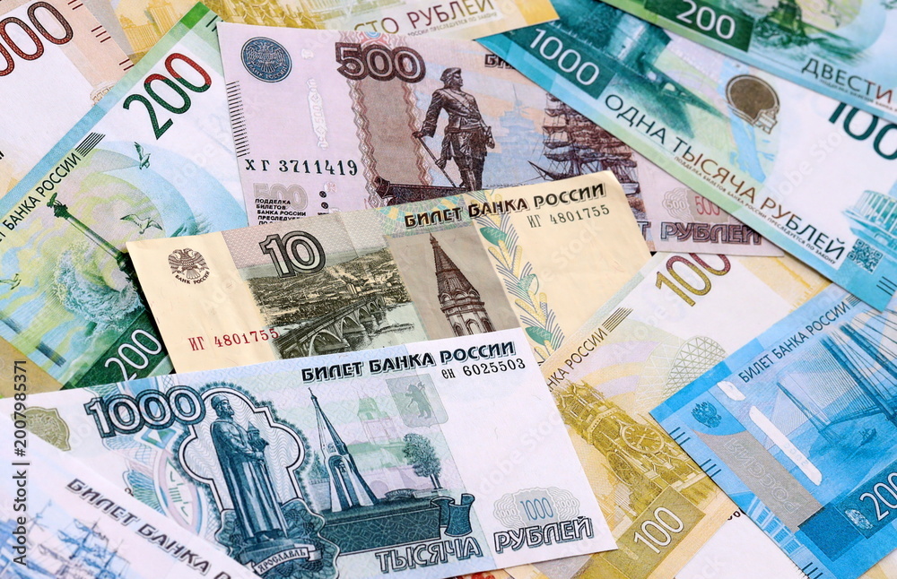Fototapeta premium Russian ruble money bills pile on table. Russia banknotes of RUB currency close up.