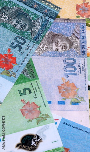 Malaysian ringgit money bills pile on table. Malaysia banknotes of MYR currency close up.