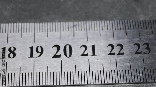 A close-up shot of a ruler with numbers and markings
