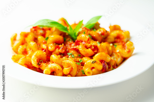 Pasta shells glisten with rich tomato sauce