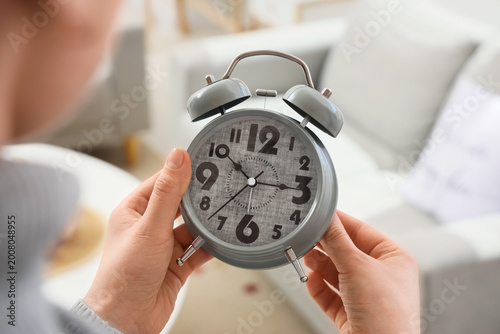 Woman changing clock for da...
