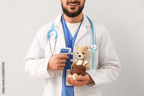 Male pediatrician with toy ...