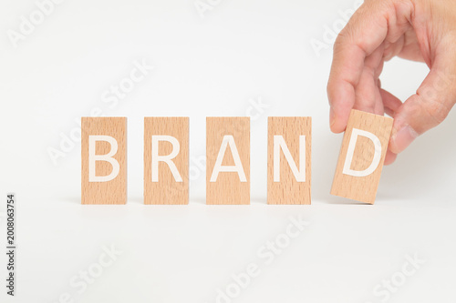 Business concept of BRAND represented on wood blocks. Ideal for marketing and promotional content.