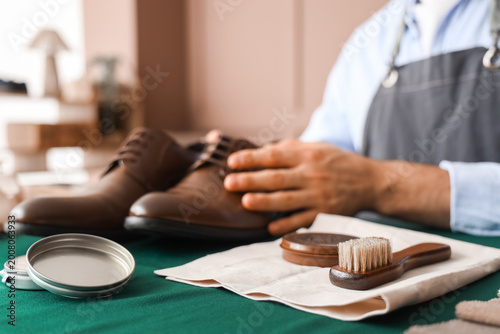 Male shoemaker with leather...