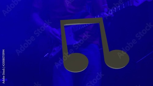 Opening chord cueing low framing, player fretting and picking while lights shifting to accent song