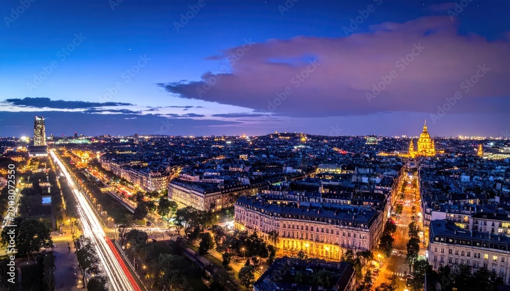 Fototapeta premium City lights twinkle beneath a twilight sky, showcasing boulevards and buildings