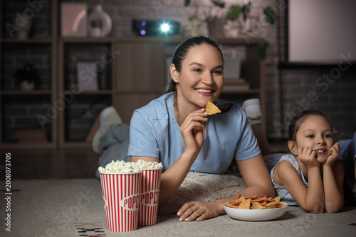 Family watching movie together at home