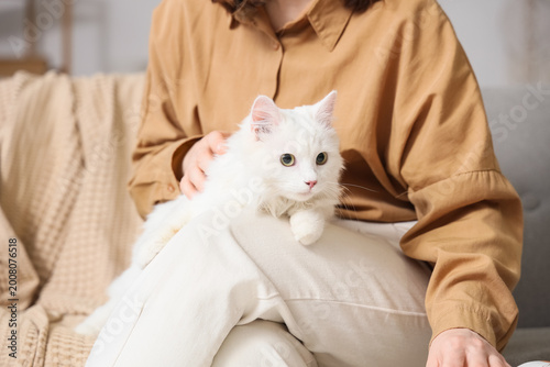 Woman with cute white cat s...
