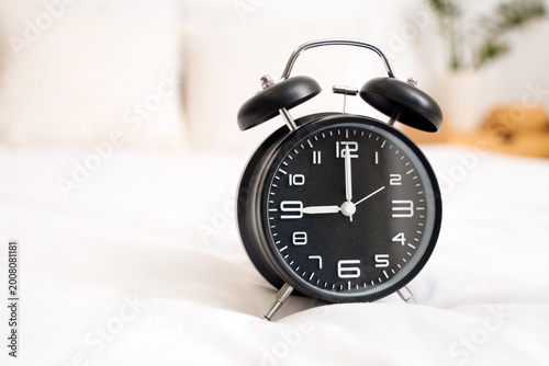 Retro alarm clock on bed in...