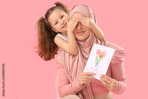 Little girl covering her Mu...