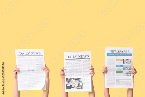 Female hands with newspaper...