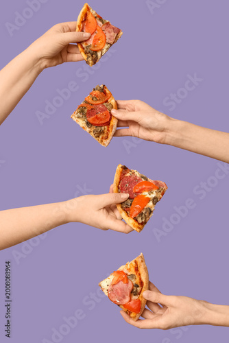 Many hands holding tasty pi...