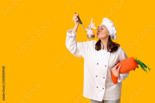 Happy female chef with ladl...
