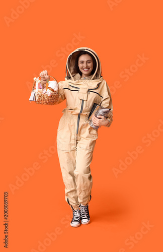 Happy female beekeeper in p...