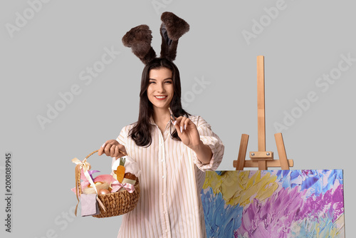 Happy female artist in bunn...