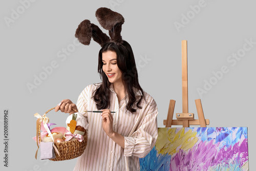 Happy female artist in bunn...