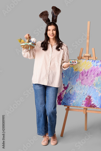 Happy female artist in bunn...