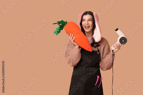 Happy female hairdresser in...