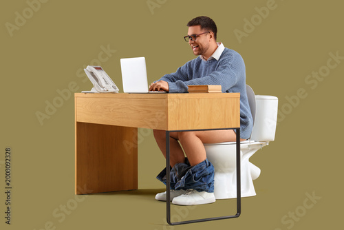 Young businessman on toilet...