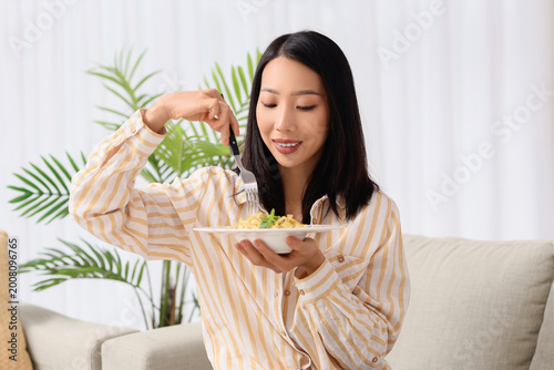 Young Asian woman with tast...