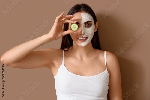 Young woman with facial mas...