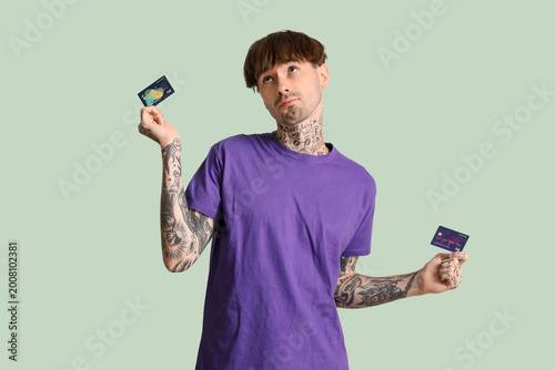 Tattooed young man with cre...