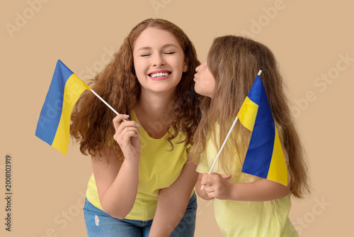 Happy little girl kissing h...