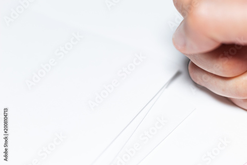 Tablou pe pânză Close-up of a clenched fist next to blank documents