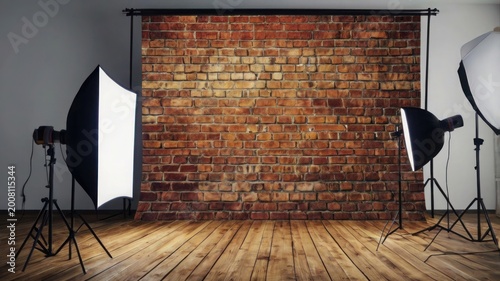 Red brick wall studio with lighting equipment and wooden floor photography