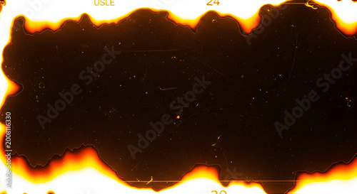 Vintage film strip with burnt edges and scratches retro cinematic texture with numerical marking