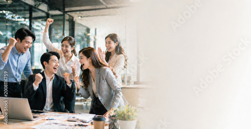 Excited business team celebrating success in office