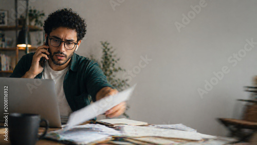 Stressed man working with laptop looking concerned