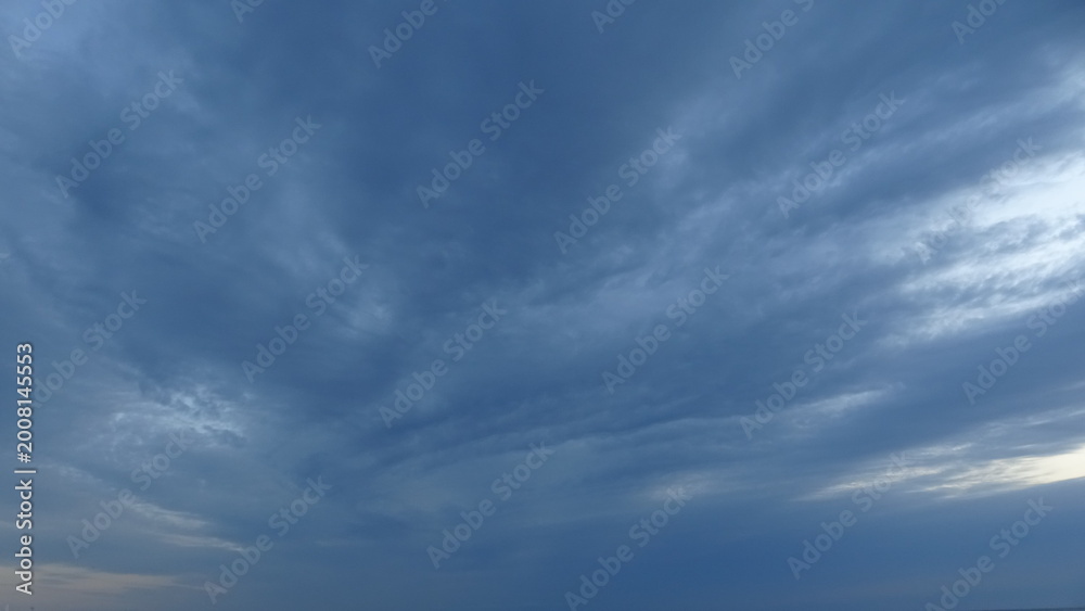 Obraz premium Moody Blue Dawn Clouds and Texture. Detailed view of the sky, featuring dramatic blue and gray cloud textures. A peaceful and meditative atmosphere of early morning light in South Korea.