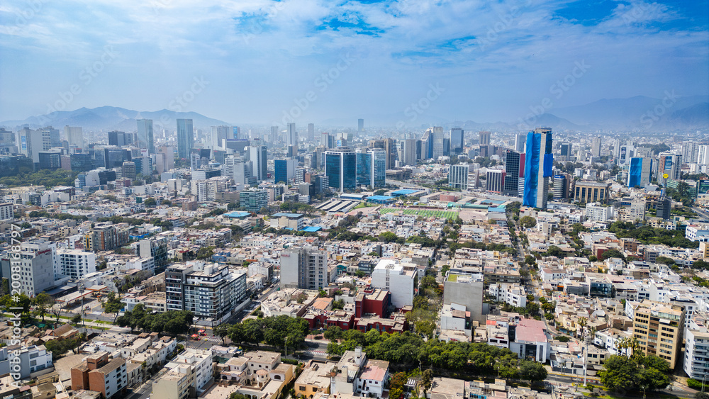 Fototapeta premium Drone photography of the modern business hub in San Isidro, Lima, featuring striking glass skyscrapers and dynamic architectural growth.