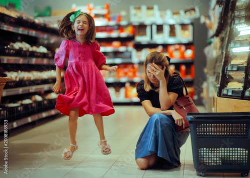 фотографія Exasperated Mom Dealing with a Loud Kind in a Supermarket